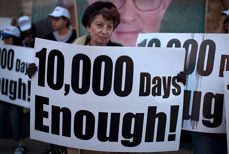A woman holds a placard during a protest calling for the release of Jonathan Pollard (who was jailed for life in 1987 on charges of spying on the United States) during a protest outside Secretary of State John Kerry's hotel in Jerusalem on April 8, 2013.
