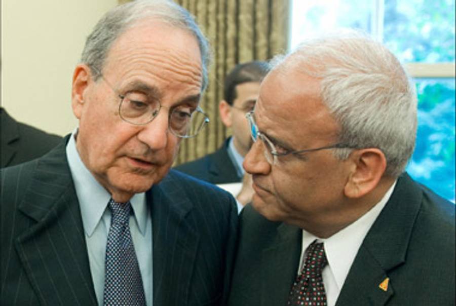 Erekat talking to George Mitchell in May.(Saul Loeb/AFP/Getty Images)