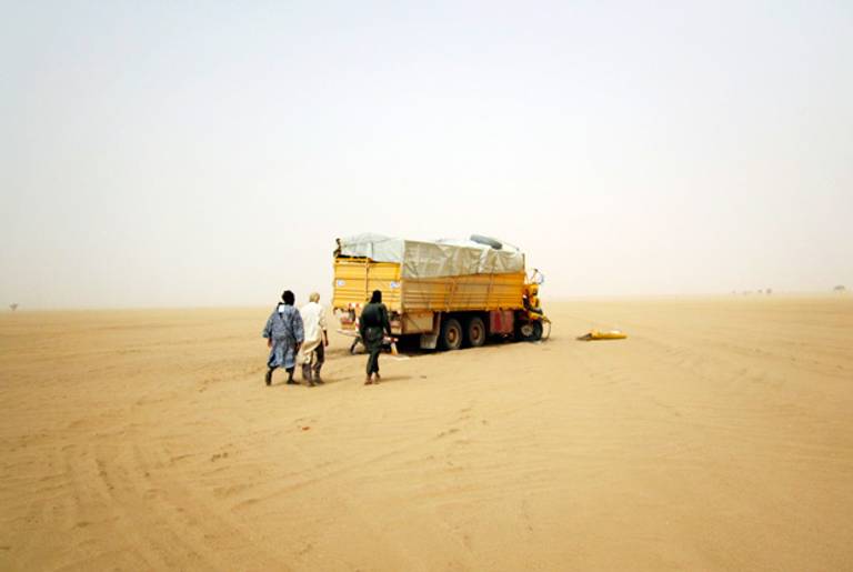 Militiamen from the Ansar Dine Islamic group approach a vehicle in the desert of northeastern Mali, June, 2012.(Reuters)