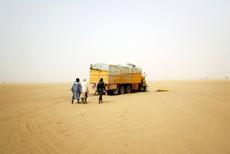 Militiamen from the Ansar Dine Islamic group approach a vehicle in the desert of northeastern Mali, June, 2012.(Reuters)
