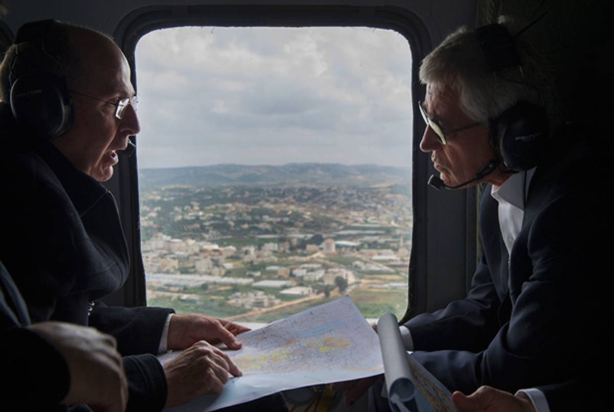 U.S. Secretary of Defense Chuck Hagel (right) and Israeli Minister of Defense Moshe Yaalon speak during a helicopter tour of the Golan Heights on April 22, 2013. (Jim Watson/Getty Images)
