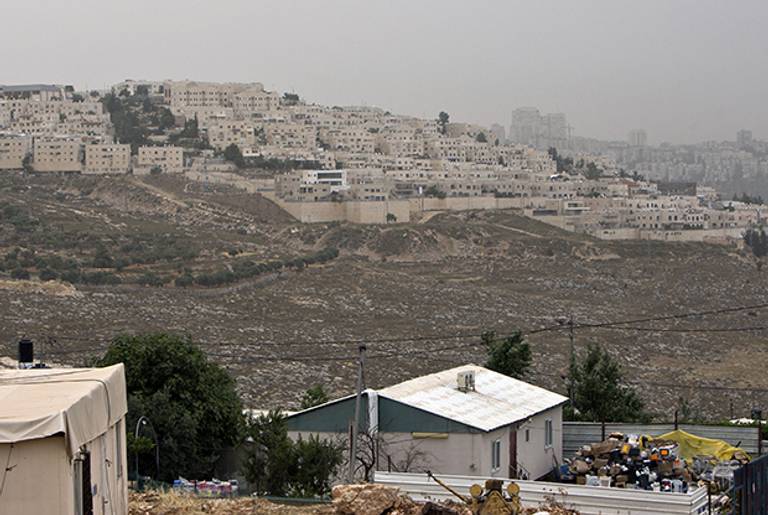 Palestinian houses in the East Jerusalem neighborhood of Beit Hanina, backdropped by a view of Ramat Shlomo, a Jewish settlement in the eastern sector of Jerusalem, on June 5, 2014. (AHMAD GHARABLI/AFP/Getty Images)