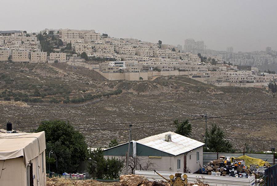 Palestinian houses in the East Jerusalem neighborhood of Beit Hanina, backdropped by a view of Ramat Shlomo, a Jewish settlement in the eastern sector of Jerusalem, on June 5, 2014. (AHMAD GHARABLI/AFP/Getty Images)