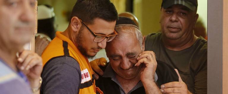 Relatives and friends mourn during the funeral of Yotam Ovadia at a Jerusalem cemetery, on July 27, 2018.