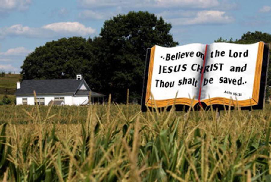 A billboard of an open Bible stands next to a Amish schoolhouse August 7, 2002 in Lancaster County, Pennsylvania.(Spencer Platt/Getty Images)