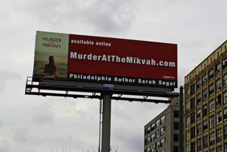 A billboard advertising Murder at the Mikvah(Newton Area Photo)