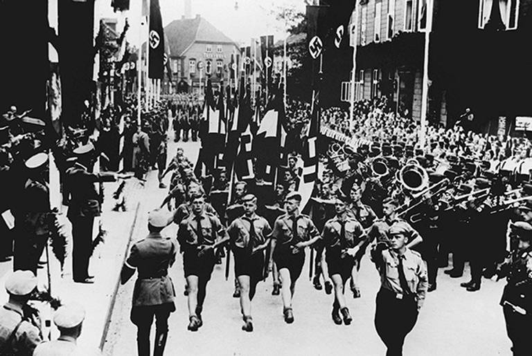 Hitler Youth units parade in the streets of Soltau in September 1937, in front of Nazi leader Adolf Hitler.(OFF/AFP/Getty Images)