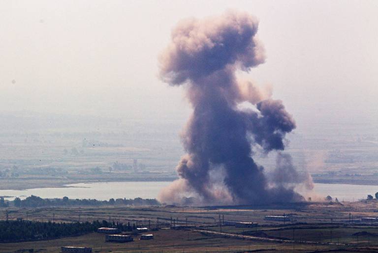 A cloud from an explosion rises near the Syrian village of Al' Rafide at the border with Israel May 7, 2013.(Uriel Sinai/Getty Images)