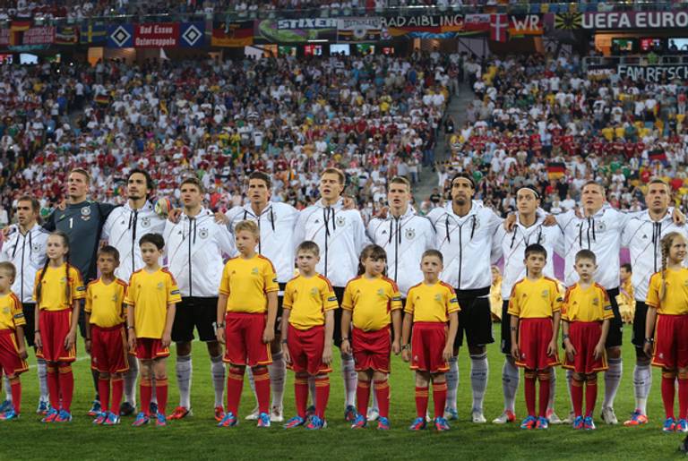 The German team lines up behind a children's soccer team on June 17, 2012, in Lviv, Ukraine. (Joern Pollex/Getty Images)