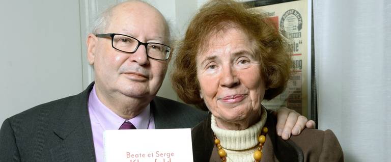 France's most famous Nazi hunters, Serge Klarsfeld and his wife Beate Klarsfeld, pose with their book 'Memoires' (Memories) in Paris on March 30, 2015. (Photo credit should read Bertrand Guay/AFP/Getty Images)