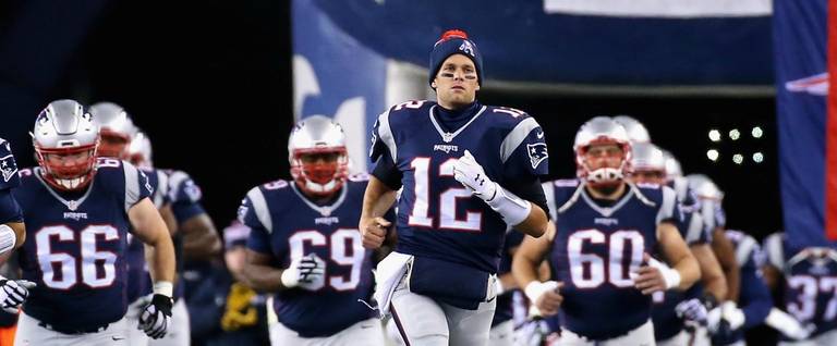 Tom Brady (#12) of the New England Patriots runs onto the field before a game against the Buffalo Bills at Gillette Stadium in Foxboro, Massachusetts, November 23, 2015.  