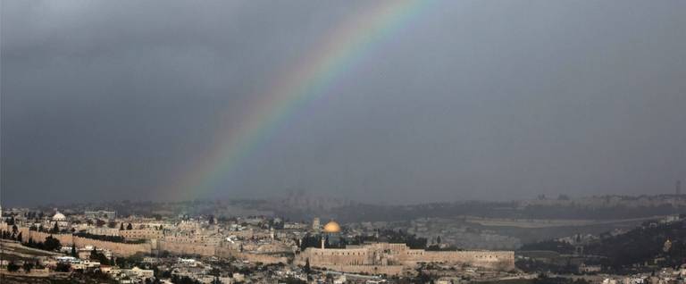 A rainbow beams across the city of Jerusalem, December 31, 2015. 