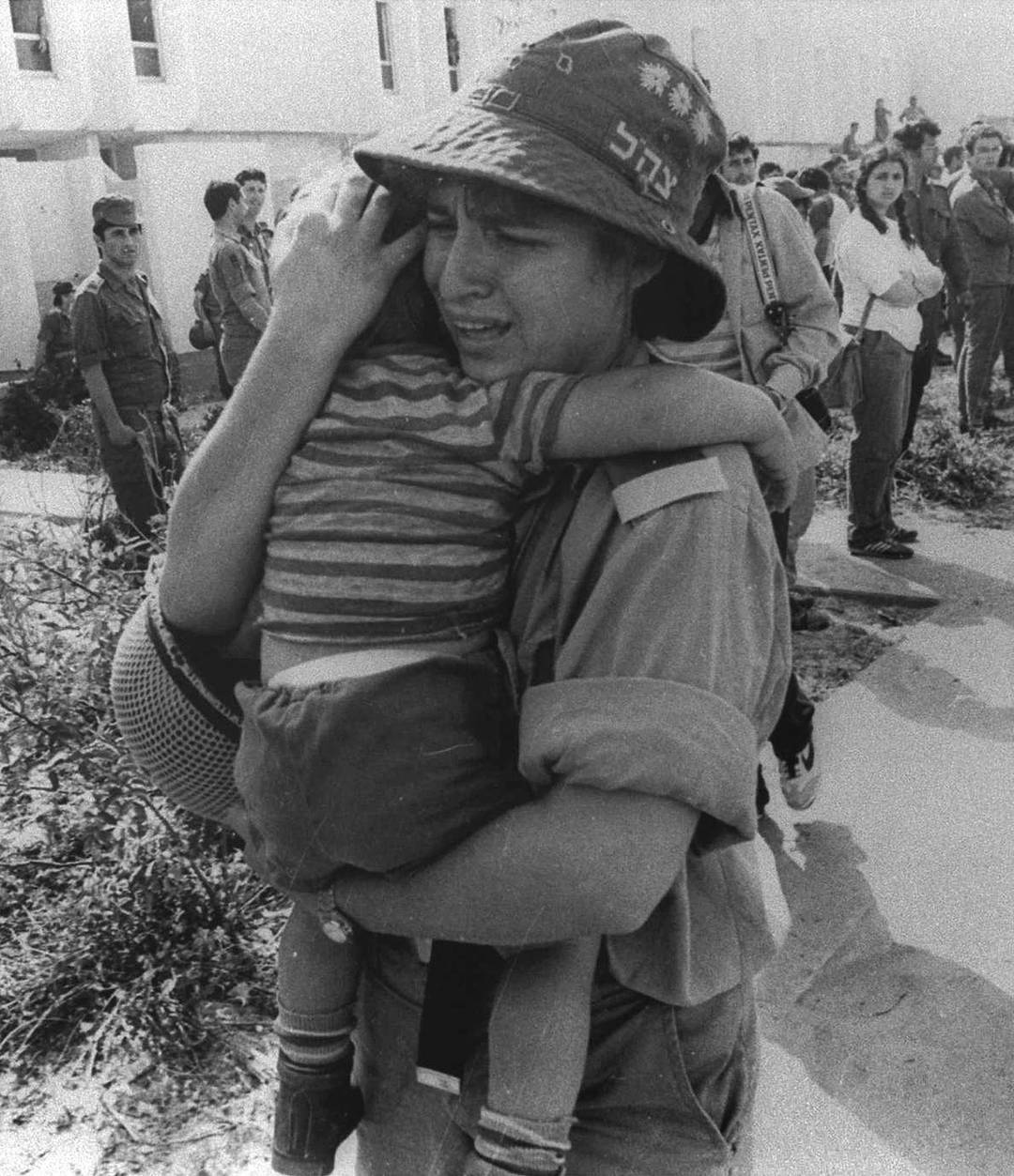 An Israeli woman soldier cries as she evacuates a Jewish settler child from an apartment building in the Sinai Desert settlement of Yamit, as part of Israel's peace treaty with Egypt, 1982