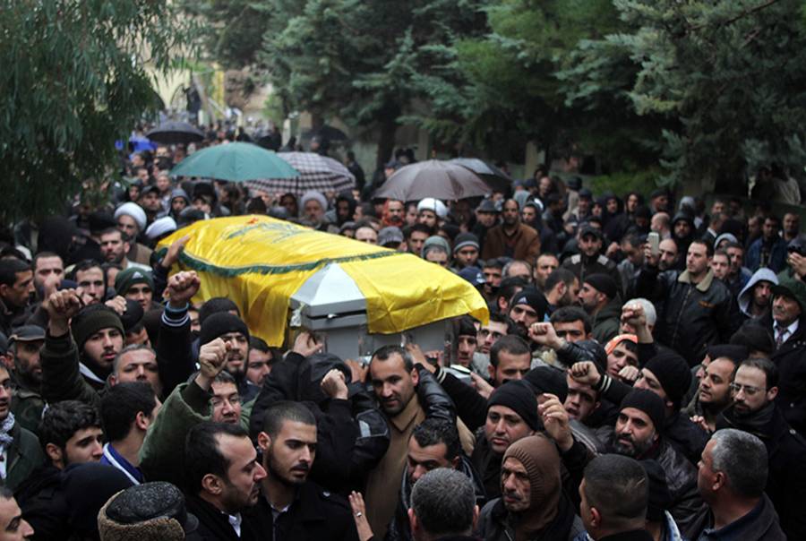 Mourners carry the coffin of Hassan Hawlo al-Lakiss, one of Hezbollah's top commanders, during his funeral in the eastern Lebanese city of Baalbek on Dec. 4, 2013.(AFP/Getty Images)