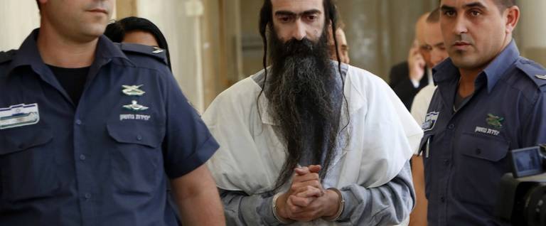 Yishai Shlissel (C) is brought to the Jerusalem Magistrate's Court in Jerusalem, Israel, July 31, 2015. 
