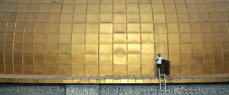 A man stands by a door at the Dome of the Rock, in Jerusalem's Old City, September 29, 2015. 