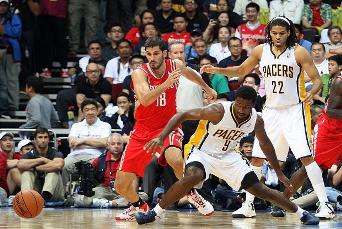  Omri Casspi #18 of the Houston Rockets reacts after Solomon Hill #9 loses the ball as Chris Copeland #22 of the Indiana Pacers looks on during the NBA game at the Mall of Asia Arena on October 10, 2013 in Manila, Philippines.(Mike Young, Getty)