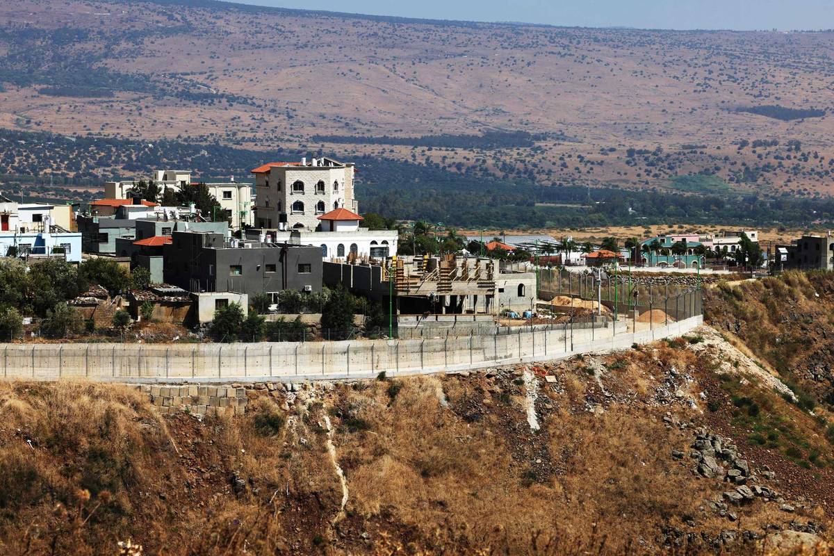A picture taken from the southern Lebanese village of Wazzani shows the northern part of the border village of Ghajar recently walled by Israel, on July 21, 2023. Lebanon's Foreign Ministry on July 11 said the country would file a complaint with the U.N. Security Council over Israel's 'annexation' of the north of Ghajar. The so-called Blue Line cuts through Ghajar, formally placing its northern part in Lebanon and its southern part in the Israeli-occupied and annexed Golan Heights.