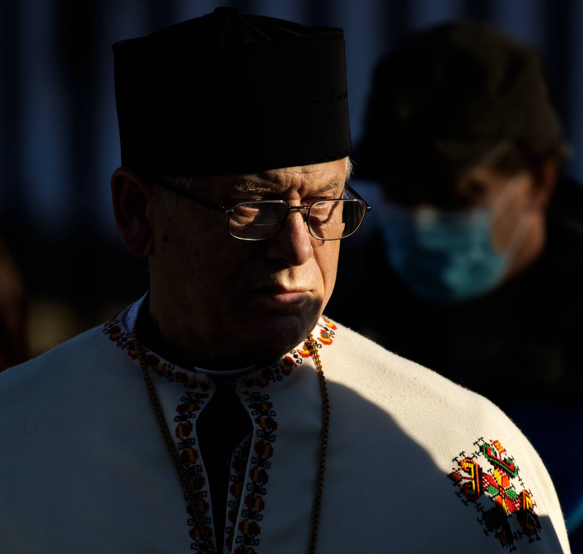 A clergyman in the Orthodox Church of Ukraine stands with pro-Ukrainian activists during a prayer and demonstration against Russian aggression in front of the White House, on Feb. 6, 2022