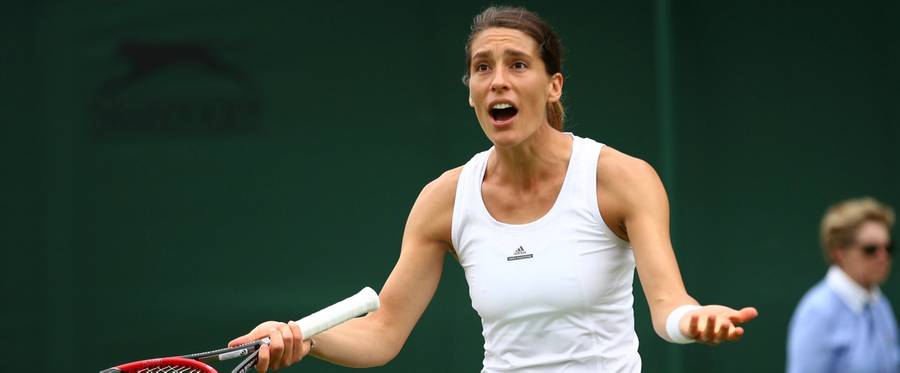 Andrea Petkovic of Germany reacts during the Ladies Singles first round match against Nao Hibino of Japan on day two of Wimbledon  in London, England, June 28, 2016. 