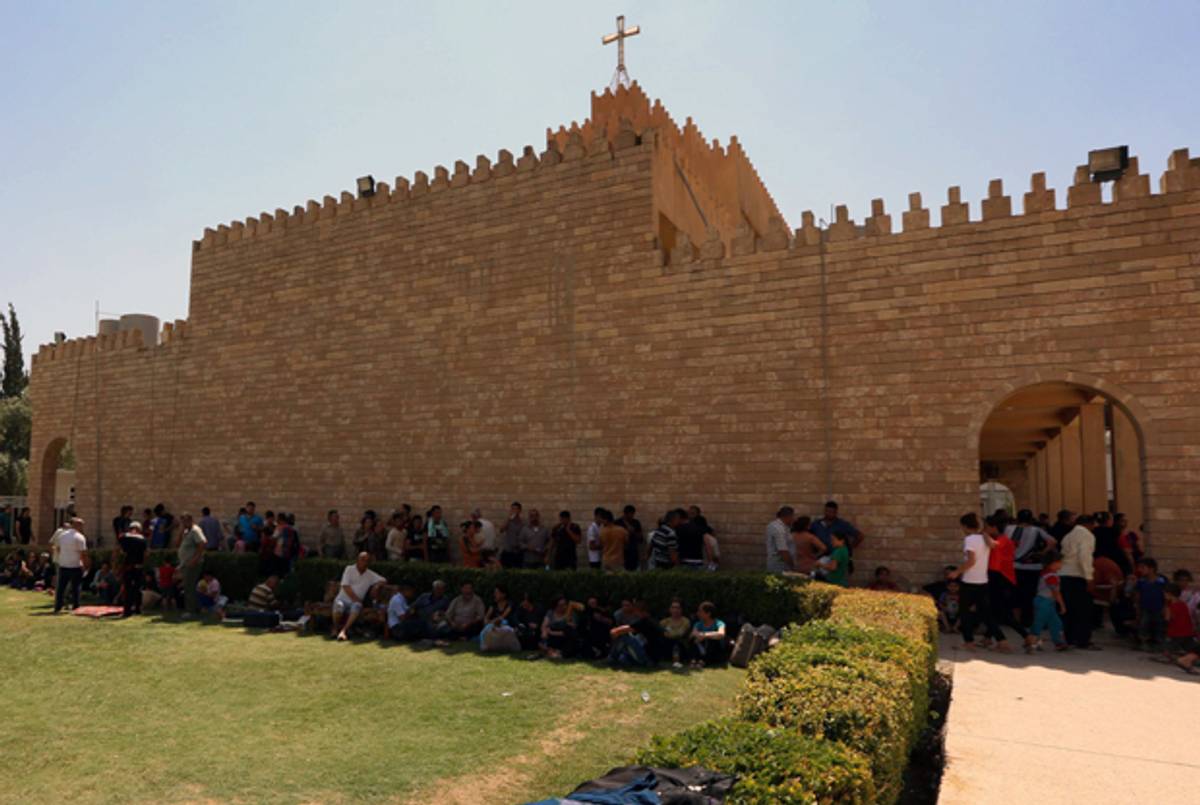 Iraqi Christians who fled the violence in the village of Qaraqush, about 30 kilometres east of the northern province of Nineveh, rest upon their arrival at the Saint-Joseph church in the Kurdish city of Arbil, in Iraq's autonomous Kurdistan region, on August 7, 2014.(SAFIN HAMED/AFP/Getty Images)