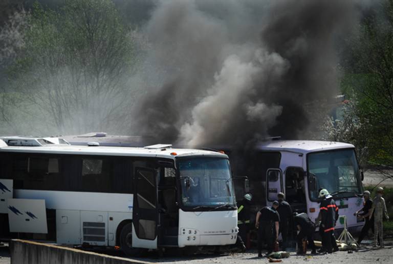 Investigators examine the site where two busses exploded on April 26, 2013 as they re-enact the July 2012 Burgas airport bus bombing that killed five Israeli tourists near the town of Ihtiman in an effort to resolve some of the many still unanswered questions.(NIKOLAY DOYCHINOV/AFP/Getty Images)
