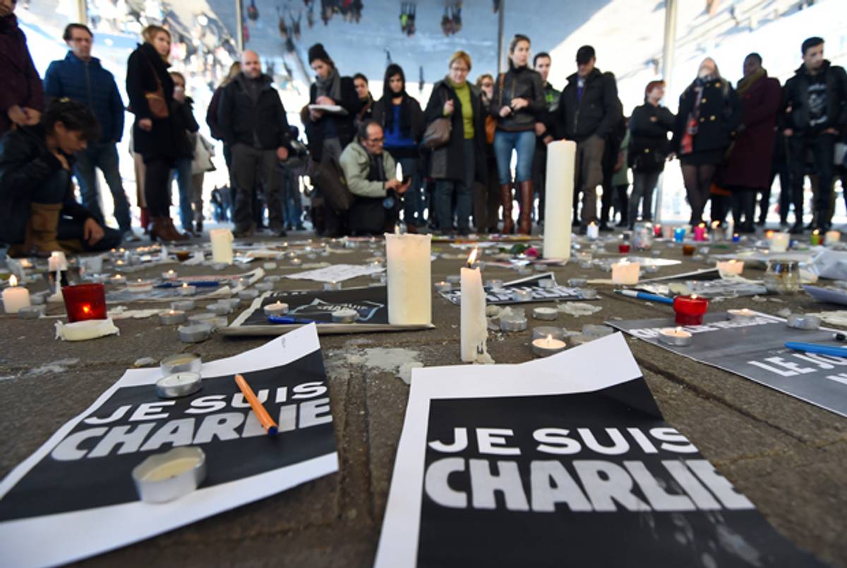 People gather next to signs reading 'I am Charlie'' in Marseille on January 8, 2015 after 12 people were killed in an attack on a satirical weekly. (ANNE-CHRISTINE POUJOULAT/AFP/Getty Images)