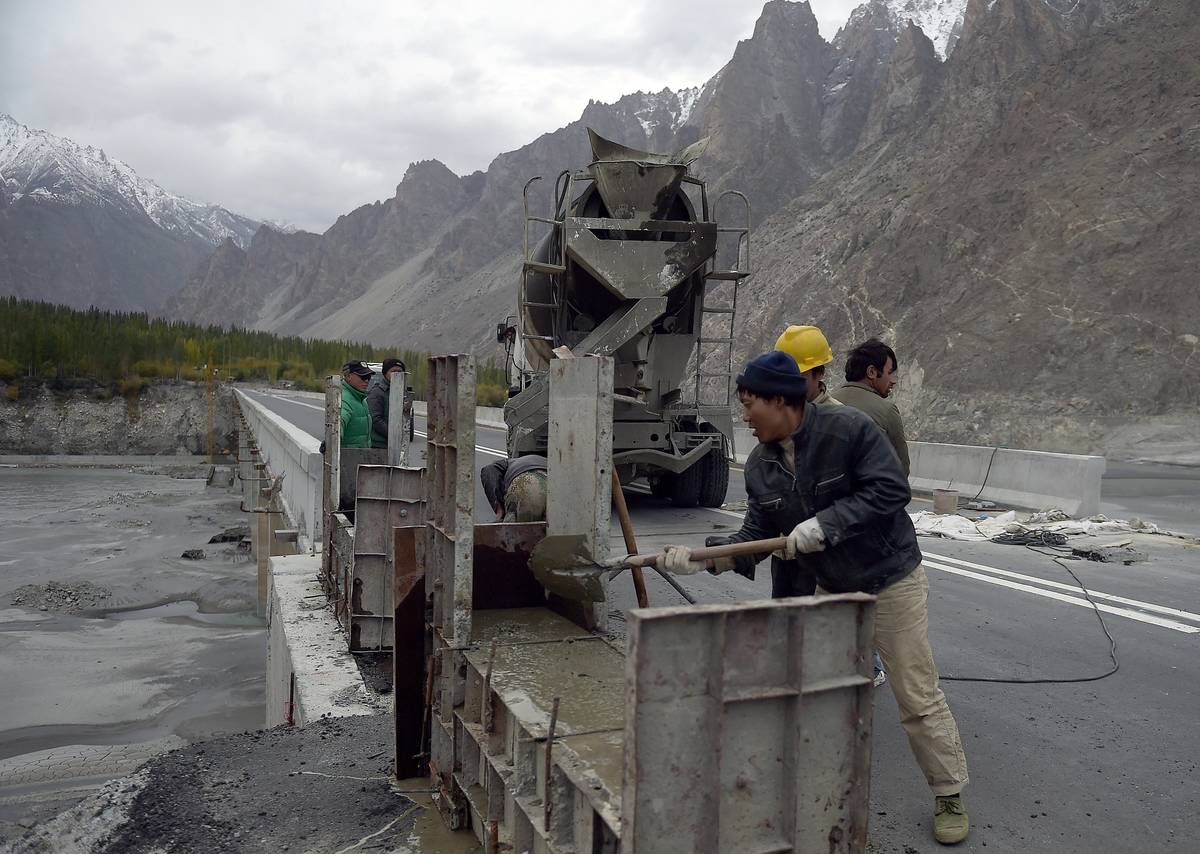 In this photograph taken on Sept. 29, 2015, Chinese laborers work on the Karakoram highway, in Gulmit village of Hunza valley in northern Pakistan