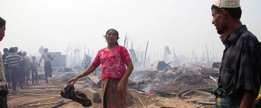 A Rohingya woman grieves after a fire gutted her family's shelter in Bawdupa camp near Sittwe, Myanmar's Rakhine state capital on May 3, 2016. A major fire on May 3 damaged or destroyed the homes of nearly 450 Rohingya Muslim families living in a camp for people displaced by 2012 communal fighting in western Myanmar. Some 140,000 people, mainly Rohingya, have been trapped in the grim displacement camps since they were driven from their homes by waves of violence between Buddhists and minority Muslims four years ago.