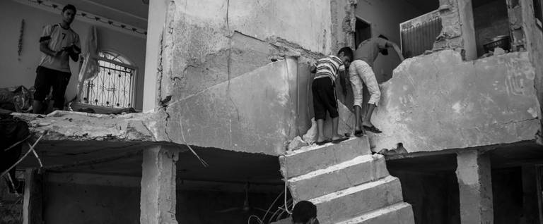 Detail, Palestinians retrieving belongings from the ruins of their house in Beit Hanoun, Gaza Strip, Aug. 12, 2014.