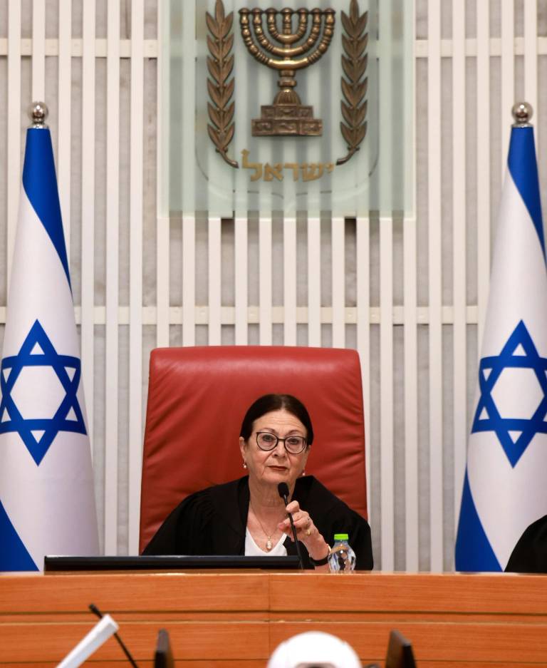 President of the Israeli Supreme Court Esther Hayut, at center, and judges assemble to hear petitions against the law that blocks the court from potentially ordering the prime minister to recuse himself from office, at the court premises in Jerusalem, on Sept. 28, 2023