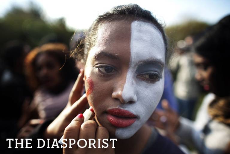 An Israeli Jew of Ethiopian origin has her face painted white during a protest against racism and discrimination, in front of the Knesset in Jerusalem, on Jan. 18, 2012.(Menahem Kahana/AFP/Getty Images)