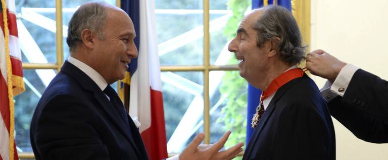 French Foreign Minister Laurent Fabius speaks with U.S. author Philip Roth after presenting Roth with the insignia of Commander of the Legion of Honor during a ceremony at the French Embassy on September 27, 2013 in New York.