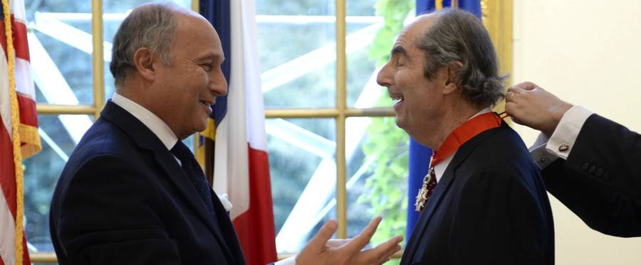 French Foreign Minister Laurent Fabius speaks with U.S. author Philip Roth after presenting Roth with the insignia of Commander of the Legion of Honor during a ceremony at the French Embassy on September 27, 2013 in New York.