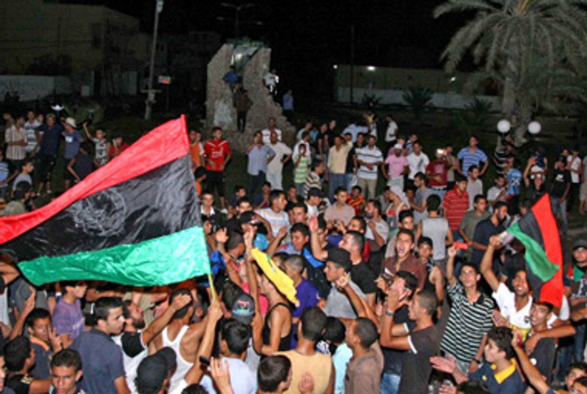 Libyan rebels celebrating outside Tripoli this morning.(-/AFP/Getty Images)