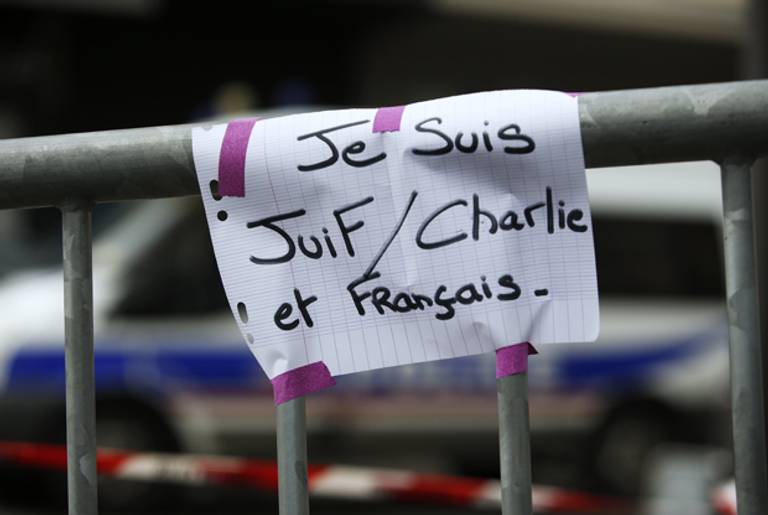 A sign reading 'I am Jewish, Charlie and French' on a security barrier near the Hyper Cacher kosher grocery store in eastern Paris on January 10, 2015. (KENZO TRIBOUILLARD/AFP/Getty Images)