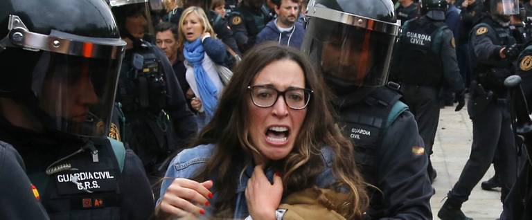People clash with Spanish Guardia Civil guards outside a polling station in Sant Julia de Ramis, where Catalan president was supposed to vote, on October 1, 2017, on the day of a referendum on independence for Catalonia banned by Madrid.