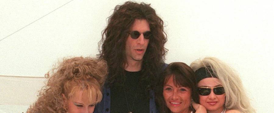 Howard Stern poses with models in Cannes, May 12, 1997. 