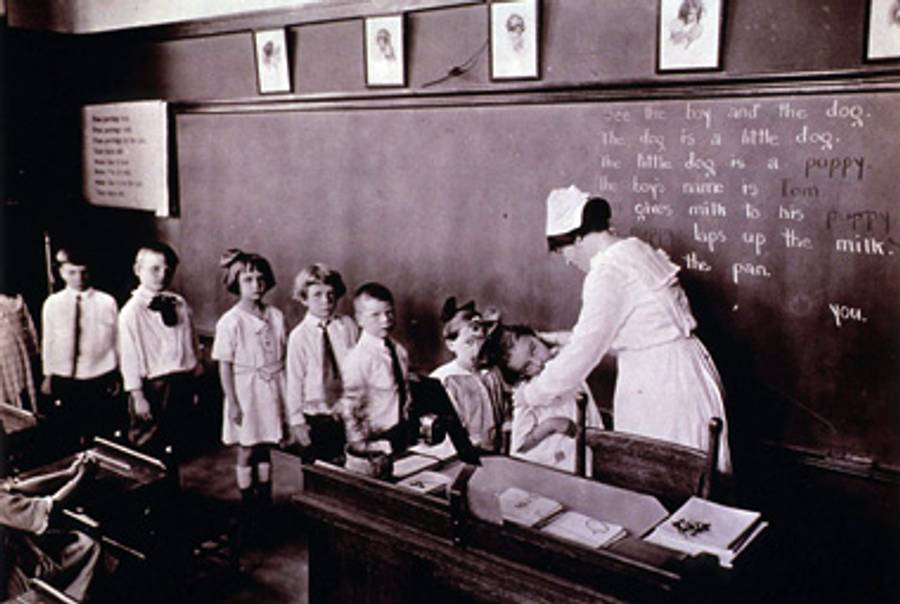 A nurse examines school hildren in New York in an undated photo.(National Library of Medicine)