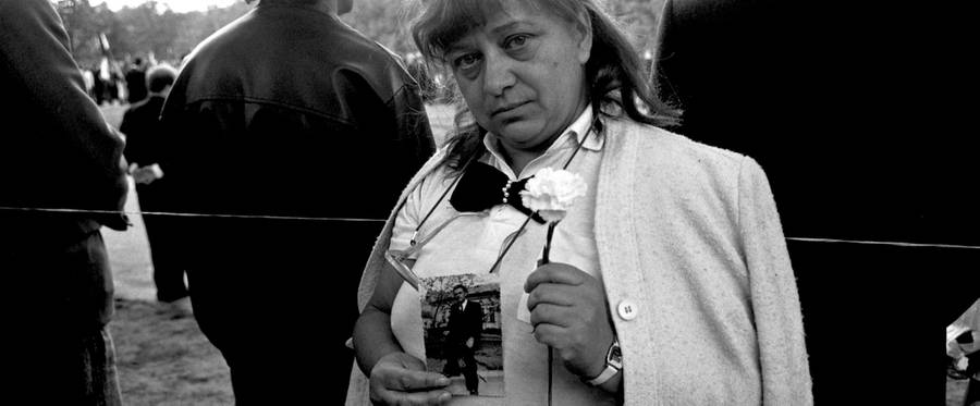 A Hungarian woman commemorating the fall of Communism in 1989 by holding up a photograph of her brother, killed by Soviet tanks in 1956