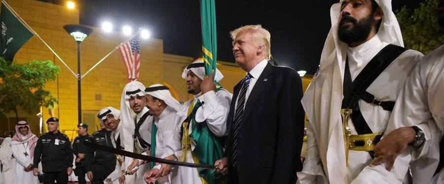 US President Donald Trump joins dancers with swords at a welcome ceremony ahead of a banquet at the Murabba Palace in Riyadh on May 20, 2017.