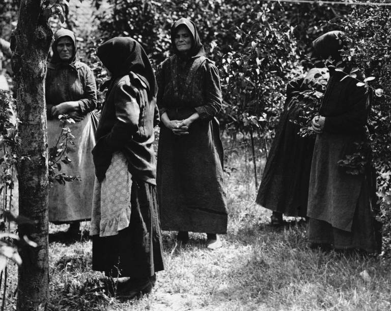 Women accused of poisoning stand in the garden of a makeshift prison in Nagyrev, Hungary, 1929