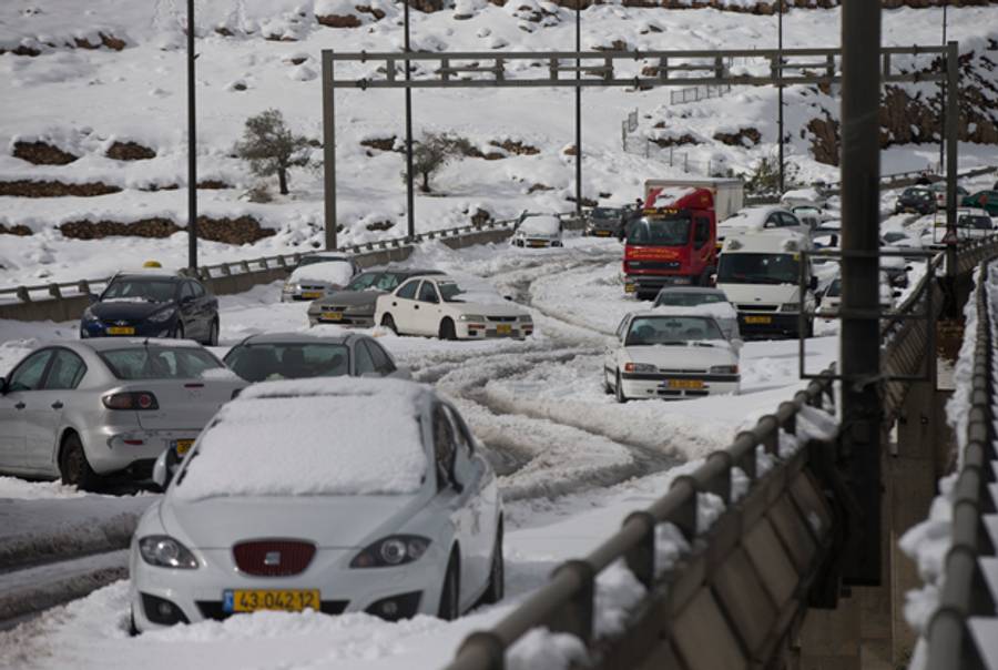 Cars sit stuck during a snow storm on highways on December 13, 2013 at the outskirts of Jerusalem, Israel. (Uriel Sinai/Getty Images)