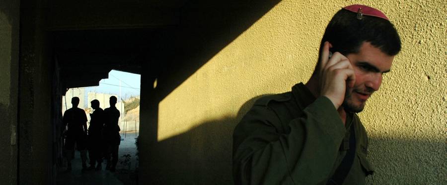 An IDF soldier on his phone on May 18, 2005, in Gush Katif.