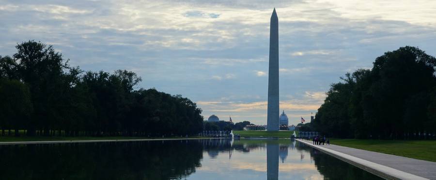 The Washington Monument and US Capitol are seen beyond the waters of the reflecting pool on the National Mall in Washington, DC on August 8, 2015. 