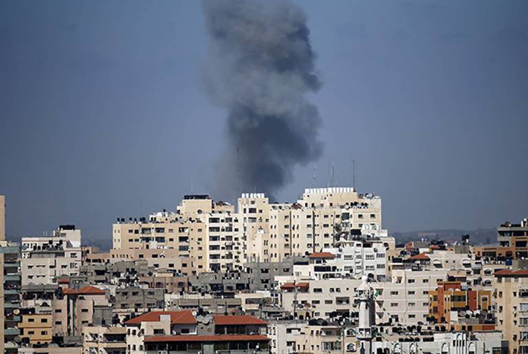 Smoke billows from a building hit by an Israeli air strike in Gaza City on July 17, 2014(THOMAS COEX/AFP/Getty Images)