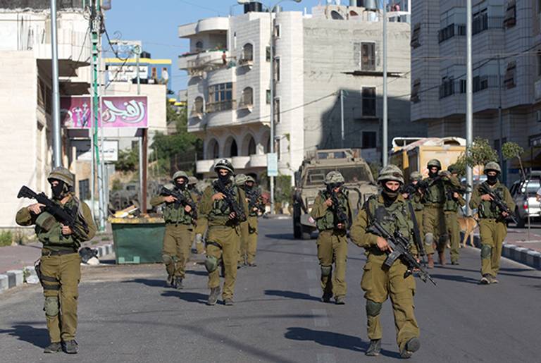 Israeli soldiers from a special army unit take part in a search operation for three Israeli teenagers believed kidnapped by Palestinian militants, on June 17, 2014 in the West Bank town of Hebron. (MENAHEM KAHANA/AFP/Getty Images)