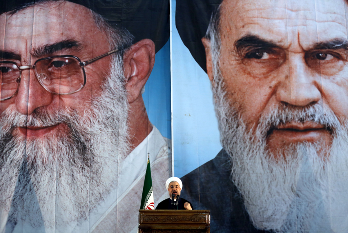 Iranian President Hassan Rouhani delivers a speech under portraits of Iran's supreme leader Ayatollah Ali Khamenei (L) and Iran's founder of the Islamic Republic, Ayatollah Ruhollah Khomeini (R), on June 3, 2014. (ATTA KENARE/AFP/Getty Images)