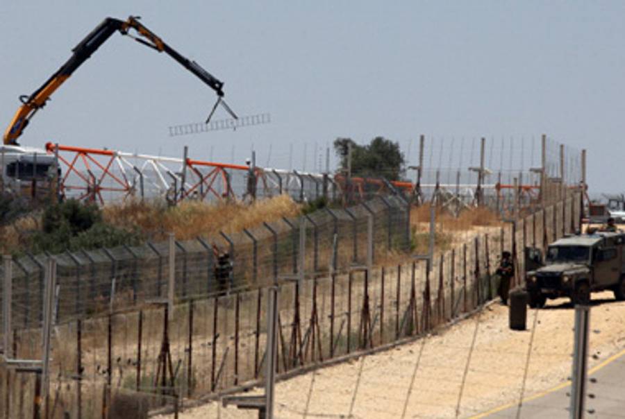Removing the fence near Bil’in today.(Abbas Momani/AFP/Getty Images)