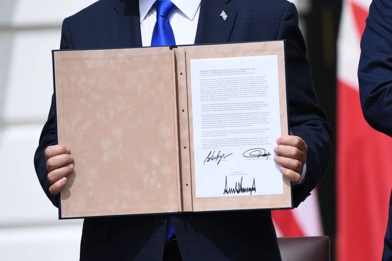 Israeli Prime Minister Benjamin Netanyahu holds up the document after participating in the signing of the Abraham Accords where the countries of Bahrain and the United Arab Emirates recognize Israel, at the White House on Sept. 15, 2020